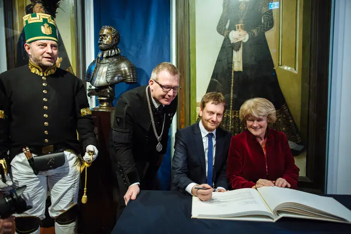 vier Personen vor einem Buch