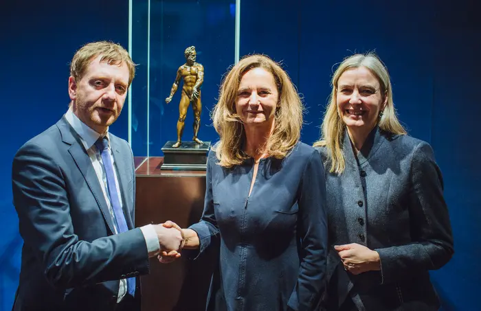 drei Personen und eine Skulptur